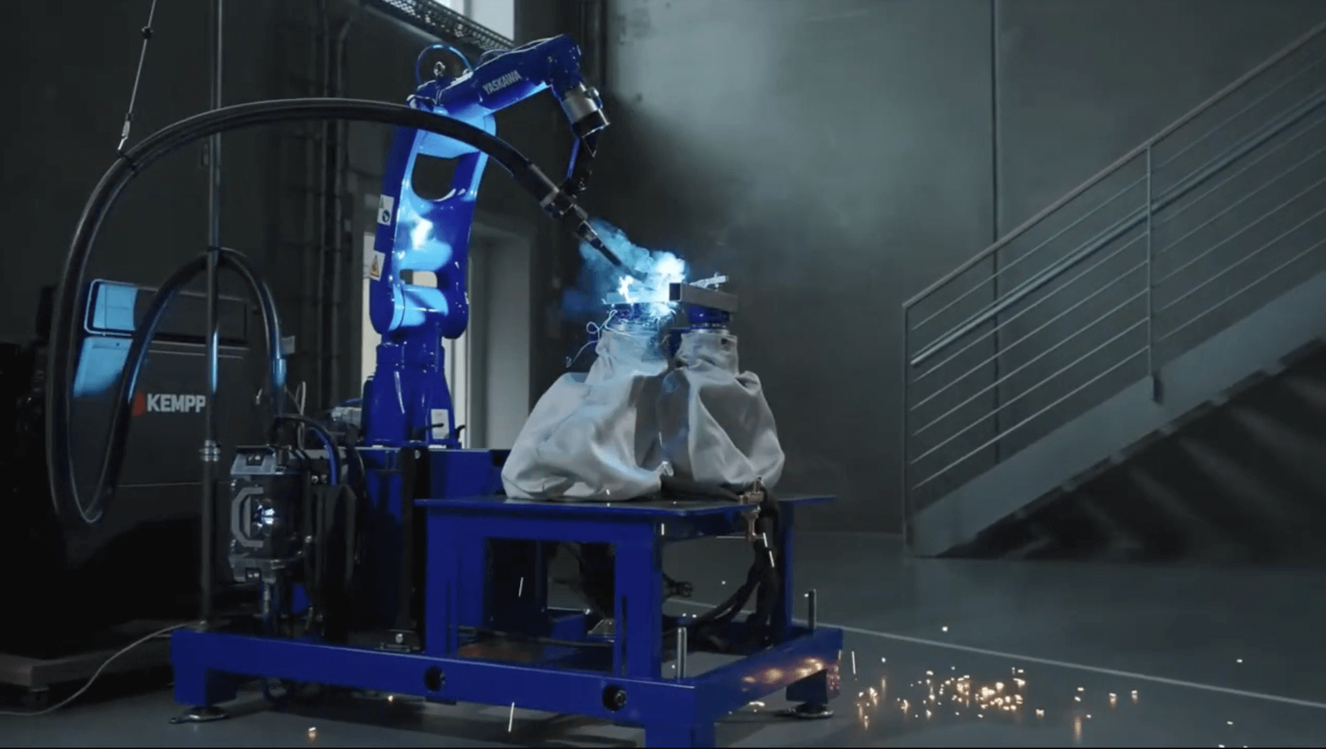Robotic welding system with FlexHex adjustable hexapod fixture performing precision MIG welding on steel components